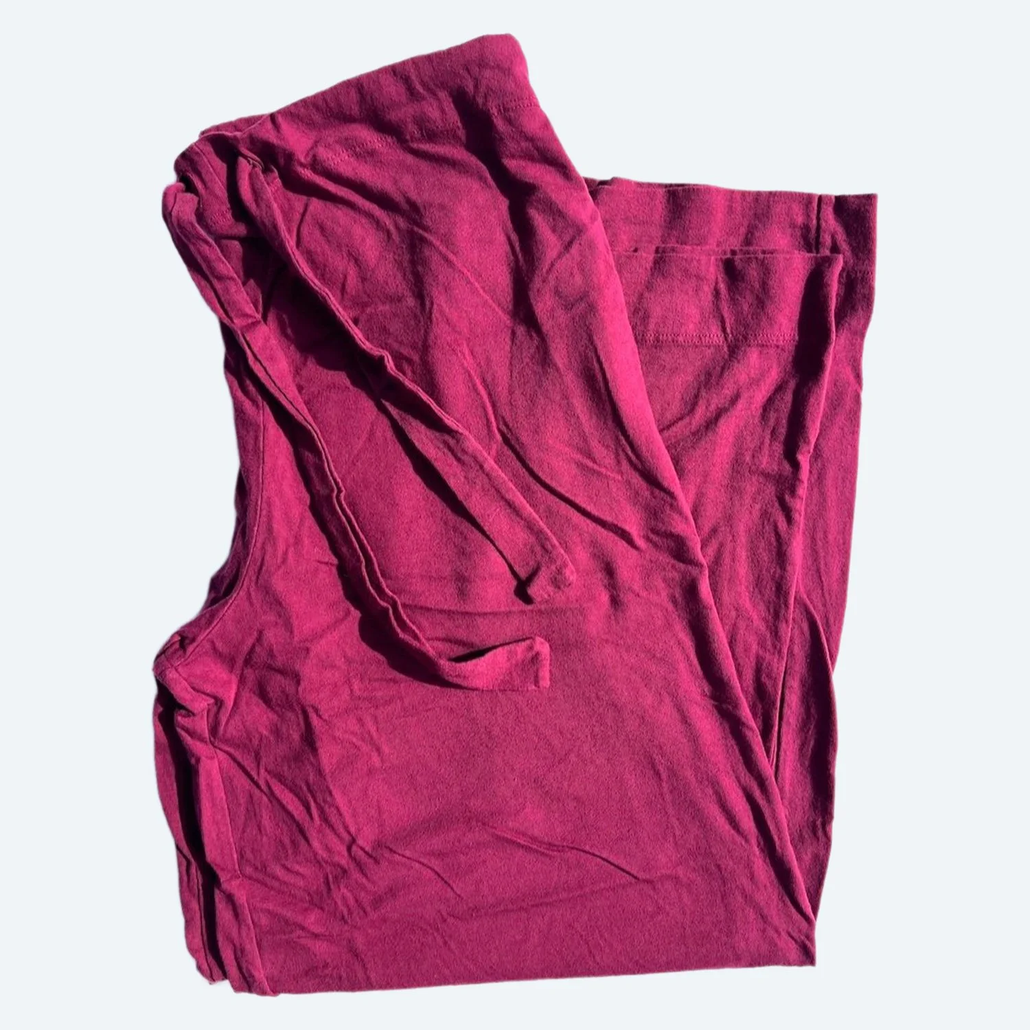 Pansy organic cotton Drawstring Pants in Wine, loosely folded to show the drawstring waistband and soft fabric.