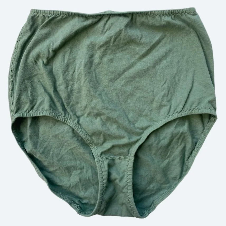 Flat lay of Pansy light xtra high rise underwear in mermaid green on a pale blue-gray background.