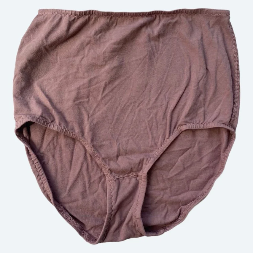 Flat lay of Pansy light xtra high rise underwear in mauve on a pale blue-gray background.