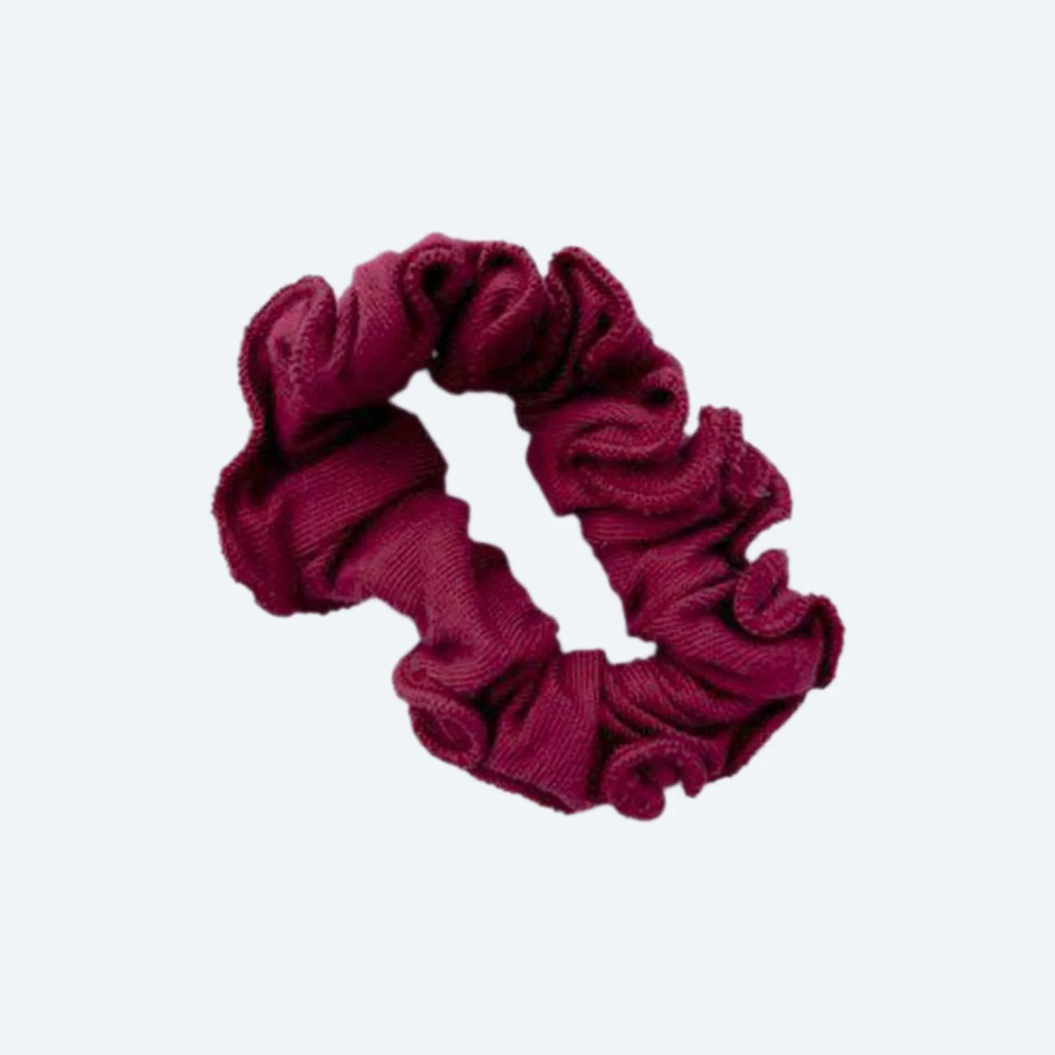 A Pansy organic cotton scrunchie in Wine, laid flat.