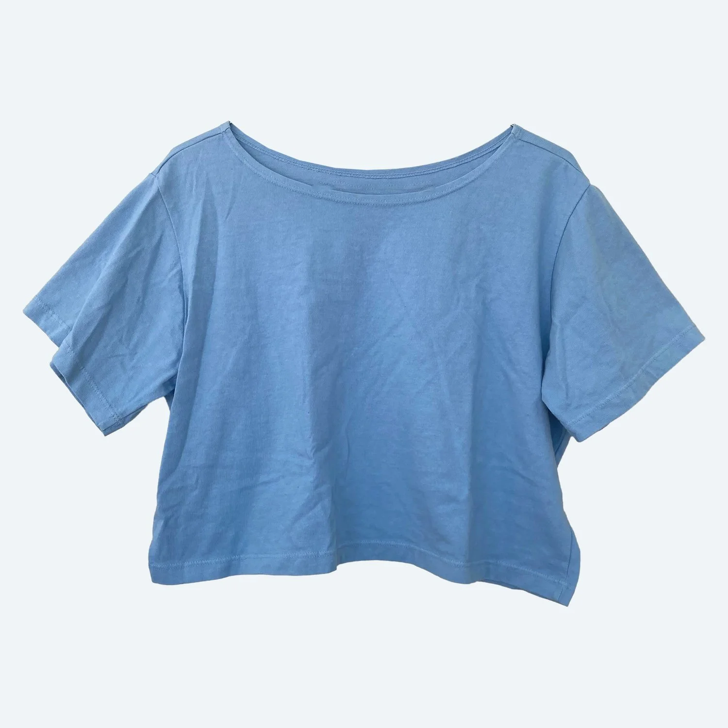 Front view of the Pansy organic cotton Crop Top in Sky blue, showing its wide neckline and short sleeves.