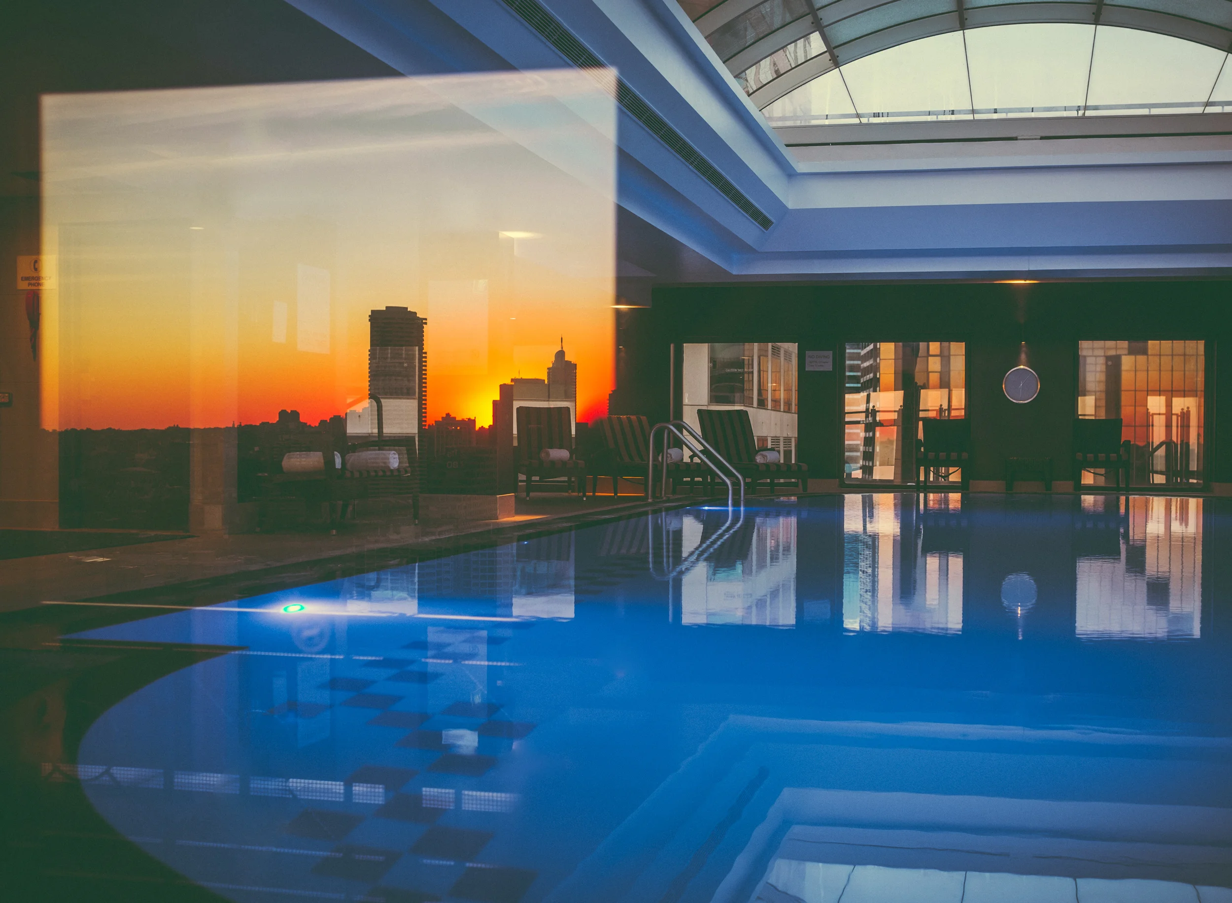 Window reflections in the pool area. Sunrise behind me before my 6am swim. This is the first photo taken on my new X100T.