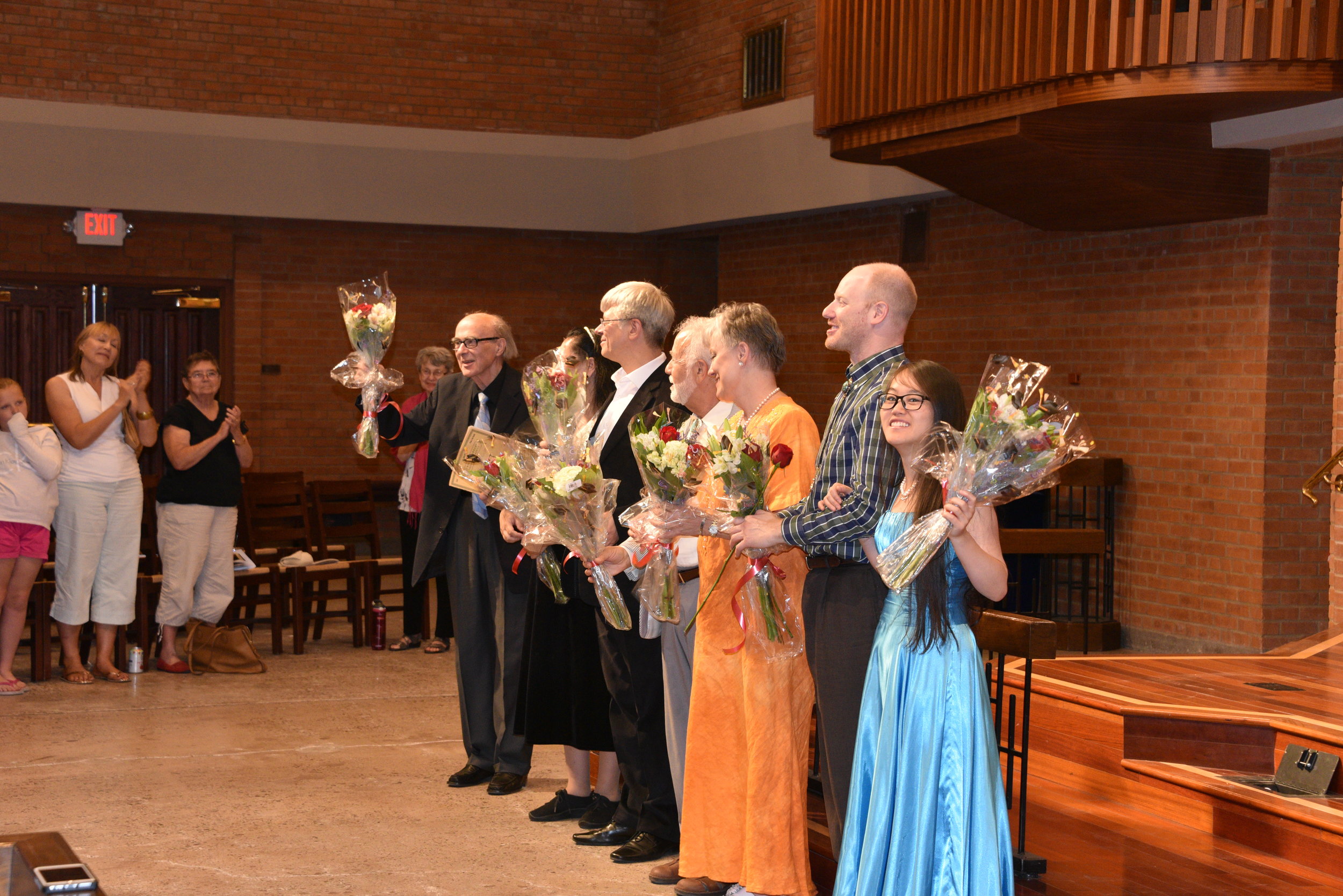 Faculty Accepting Flowers on Stage.JPG