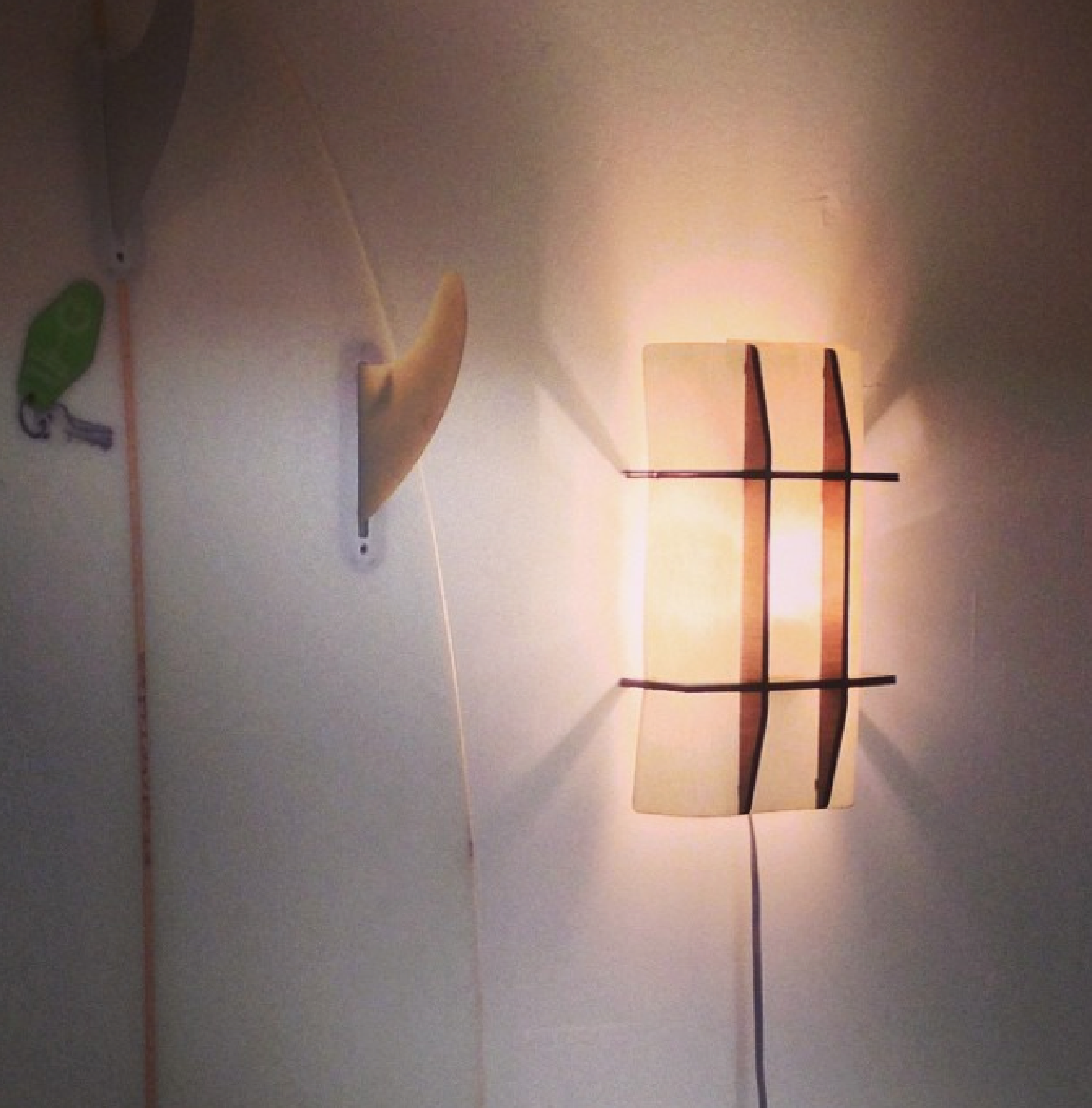 We are always looking for ways to make our products with less material. Our new 9209-431 sconce has shaken off all but the essential walnut and linen parts. Almost ready to be added to our line , it weighs only a few ounces and diffuses the warm efficient LED light with dramatic efficiency. It will be made available for mounting directly over a junction box or corded as shown. Surfboard not included. 