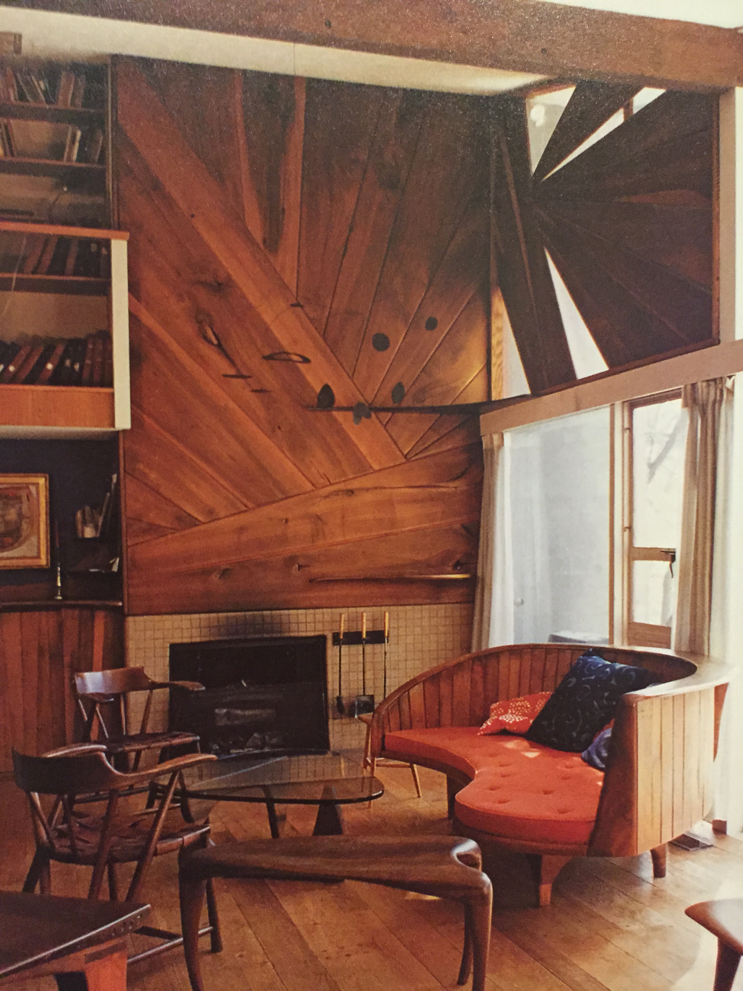 Chairs, table in foreground, sofa and wood paneling/sidingby W. Esherick.