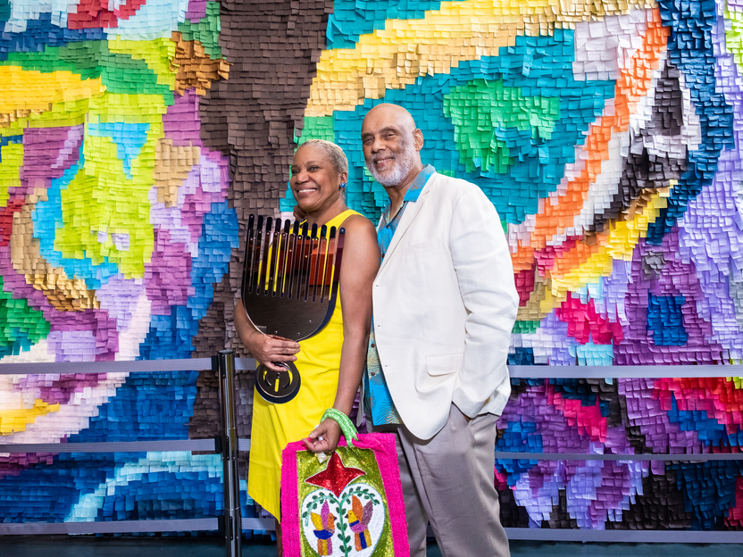 Sydney Kai Inis and her guest enjoy a piece from Artist-In-Residence Damien Davis