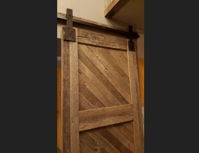  Sliding barn doors close off the back bar for private use.&nbsp;© Photo by Washington Business Journal 