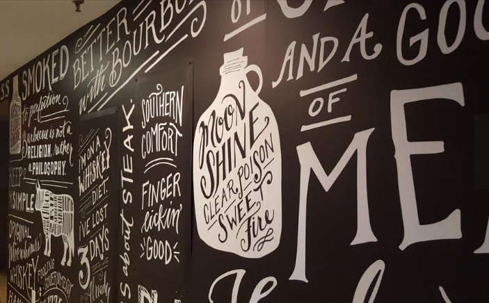  A hallway between the dining room and back lounge is influenced by the chalkboards outside of Southern barbecue joints advertising the day's offerings.&nbsp;© Photo by Washington Business Journal 