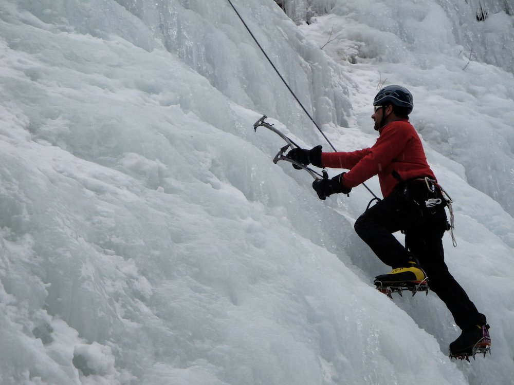 Ice climbing with ice tools and crampons