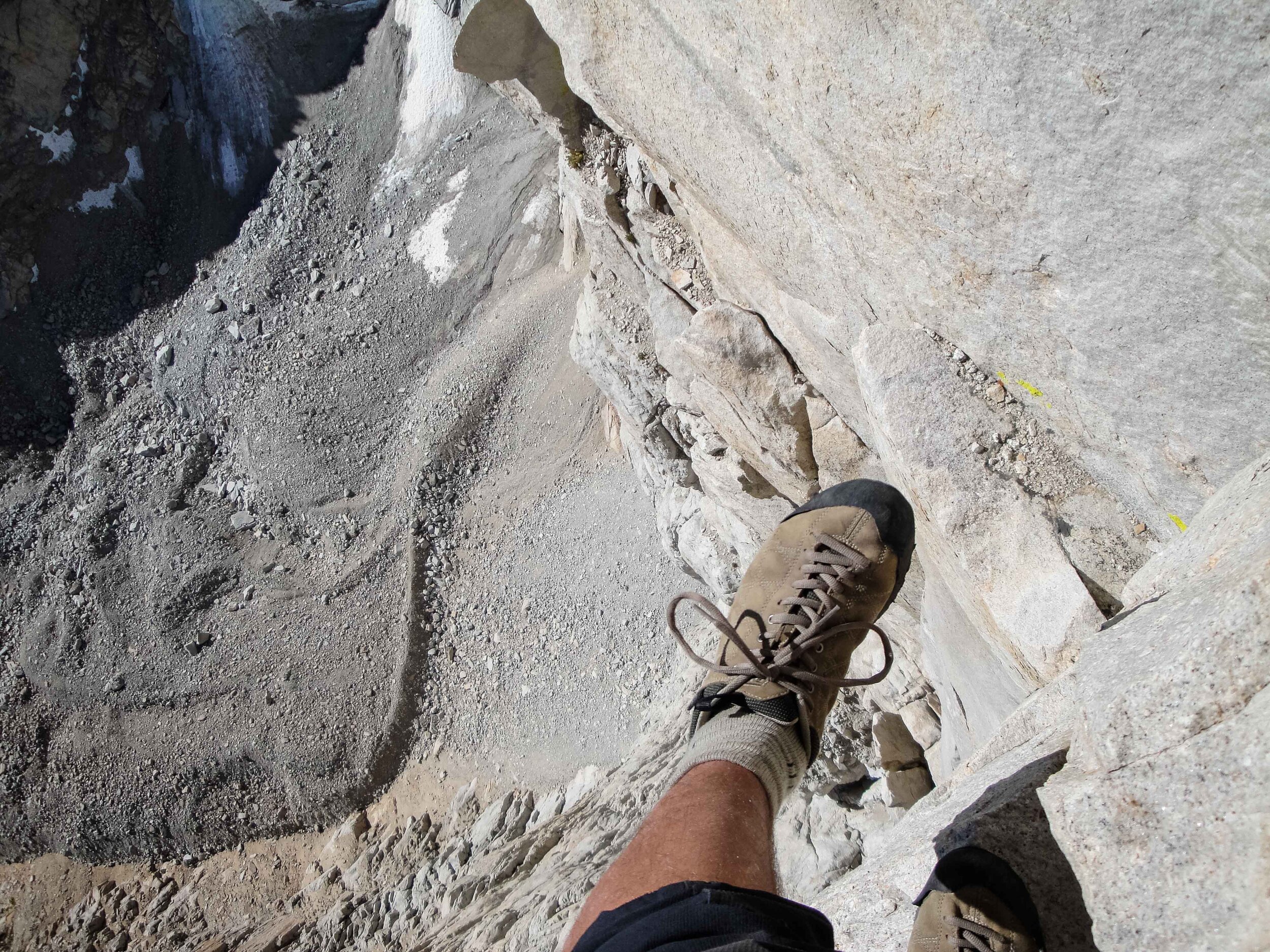 Stepping over the Fresh Air Traverse on the East Face of Mount Whitney