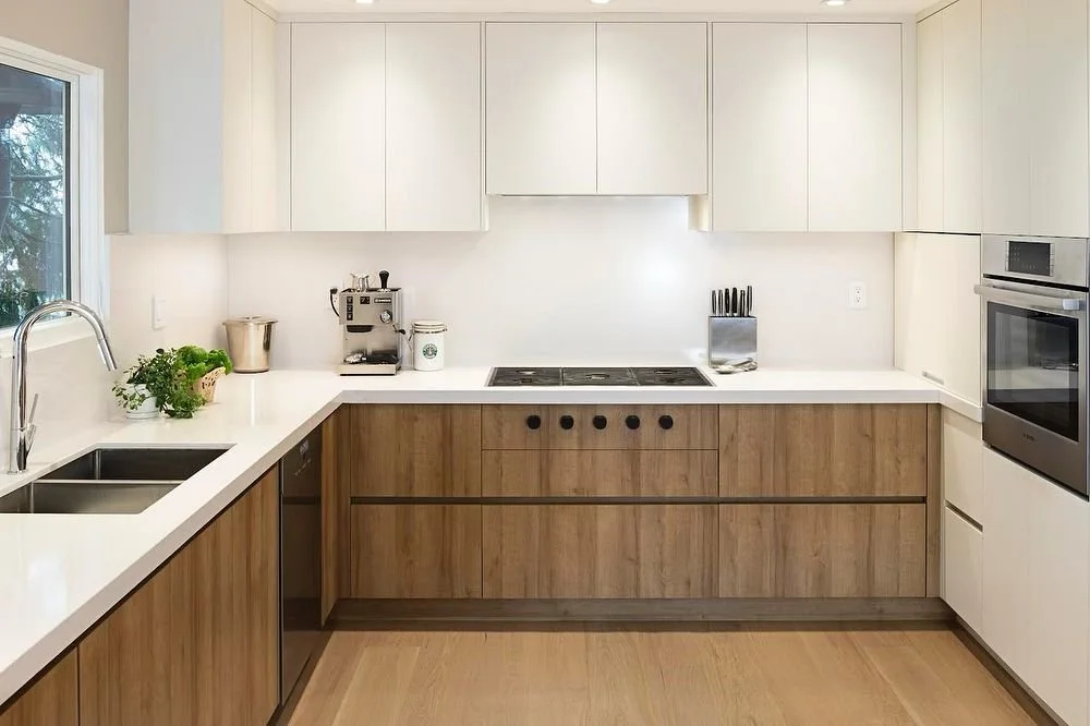 Introducing our Haversley Coquitlam project, showcasing a custom-designed kitchen equipped with Stylestone quartz countertops and matching quartz backsplash. The sleek peninsula boasts a waterfall edge, while the under-cabinet area is enhanced with s