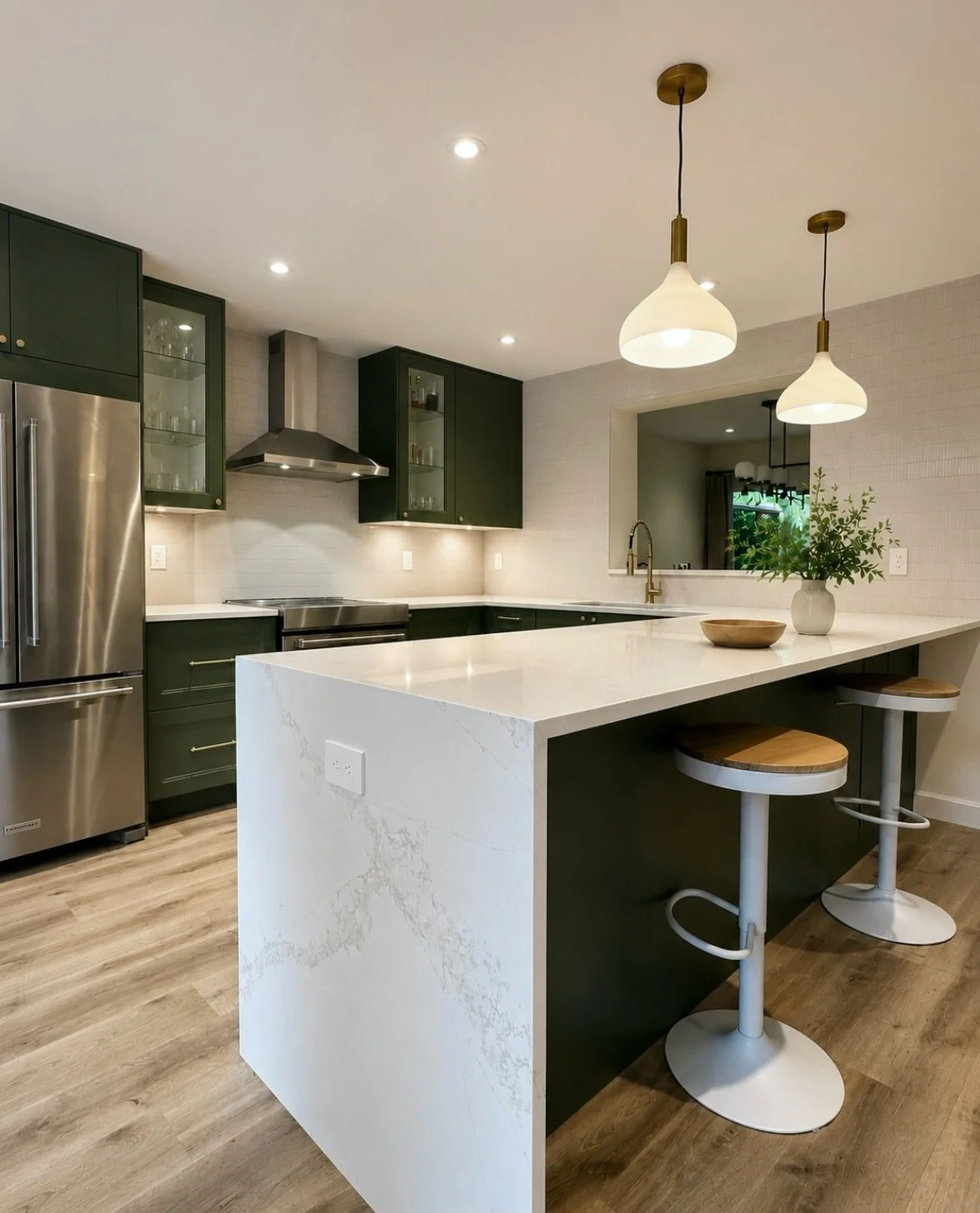 Before &amp; after of a recently completed kitchen renovation in Port Moody ✨

We removed the dividing entrance wall and replaced it with a custom peninsula featuring a waterfall countertop, creating a much larger and more functional seating area for