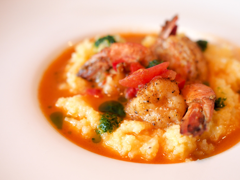 Gambas: Vadouvan spiced jumbo prawns, soft polenta, crushed tomatoes, swiss chard, and citrus brodo