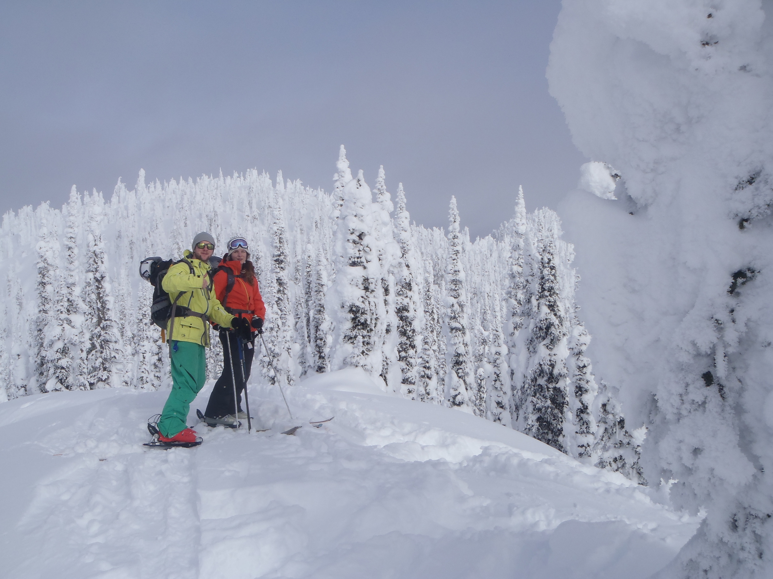 Couple backcountry skiing during a splitboarding course in BC.