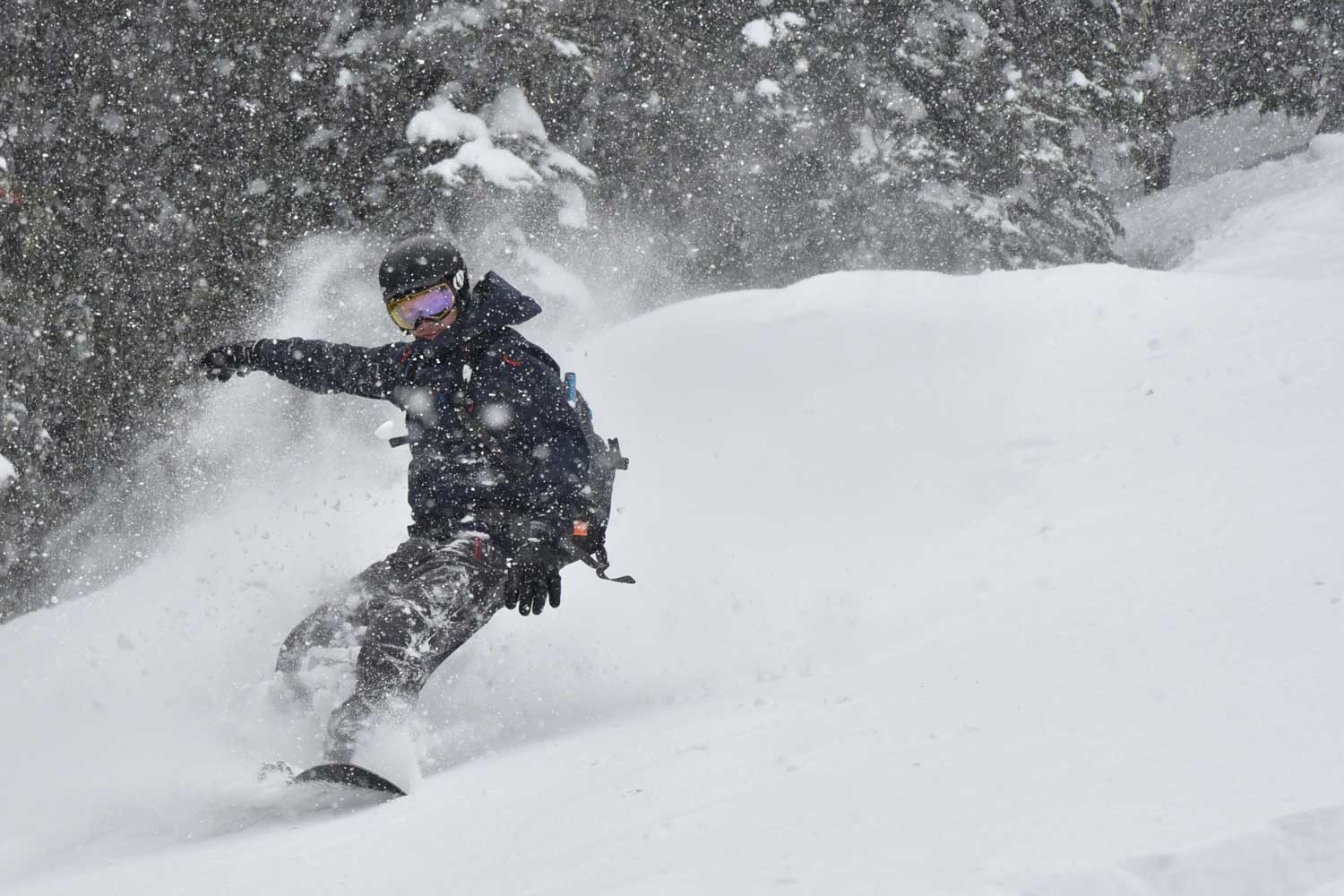 Snowboarder on a snowboard tour package in British Columbia.