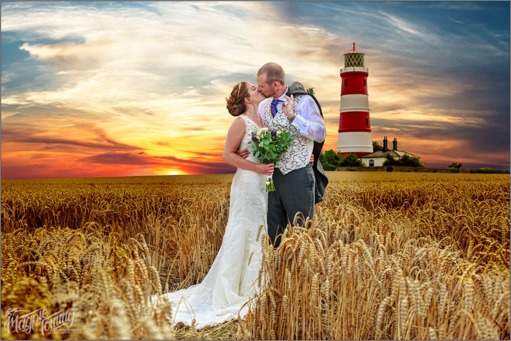 bride and groom kiss at happisburgh lighthouse norfolk wedding photography