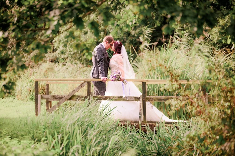 wedding at norfolk mead hotel bride and groom kisson bridge