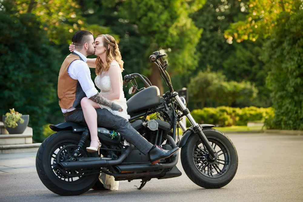 bride and groom kiss on motorbike alternative wedding norwich norfolk