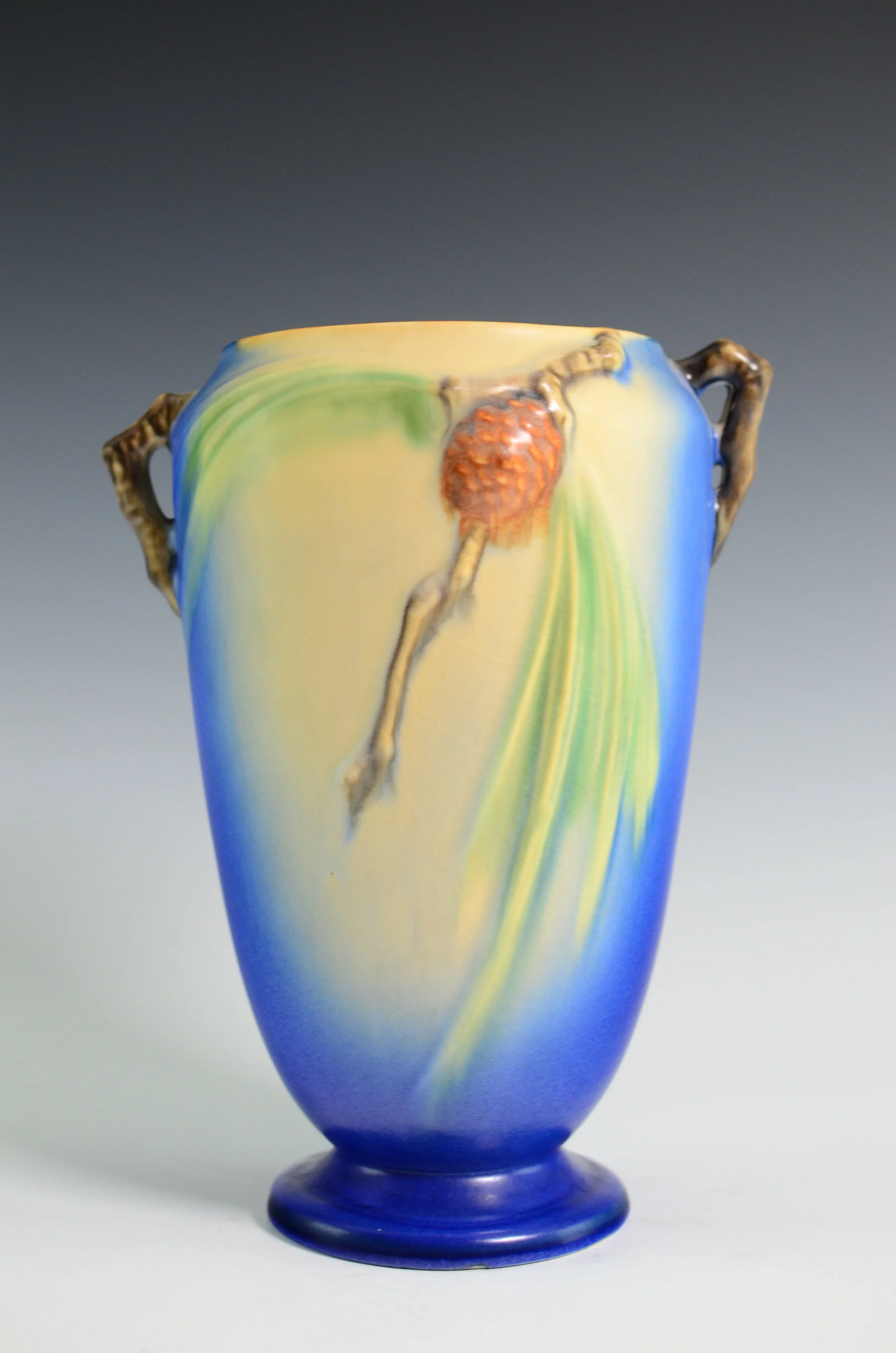 Roseville Pottery Company (1890-1954). Pine Cone Vase in Blue with Pinecone Motif