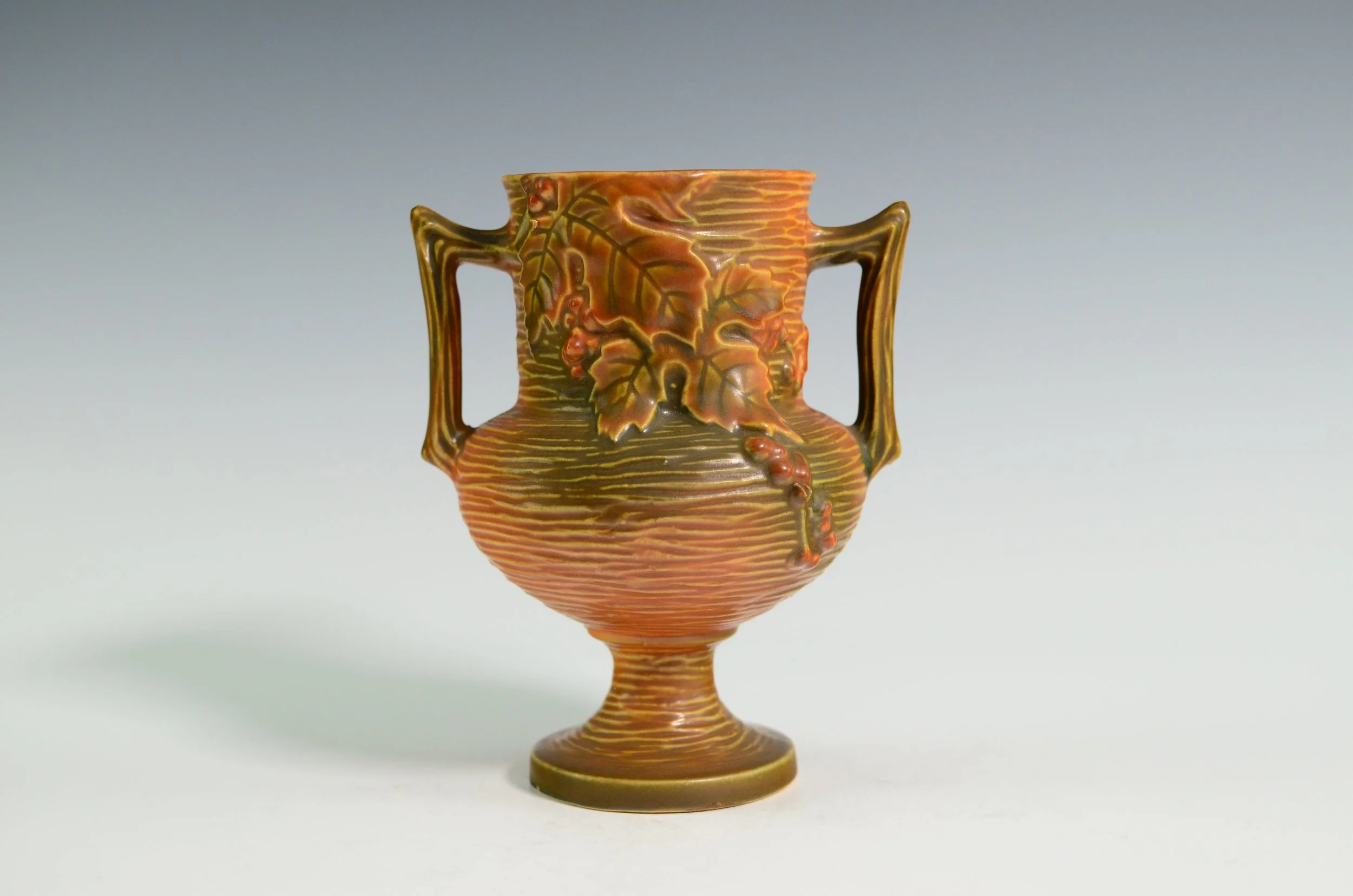 Roseville Pottery Company (1890-1954). Bushberry Vase in Woodland Orange with Leaves and Berries