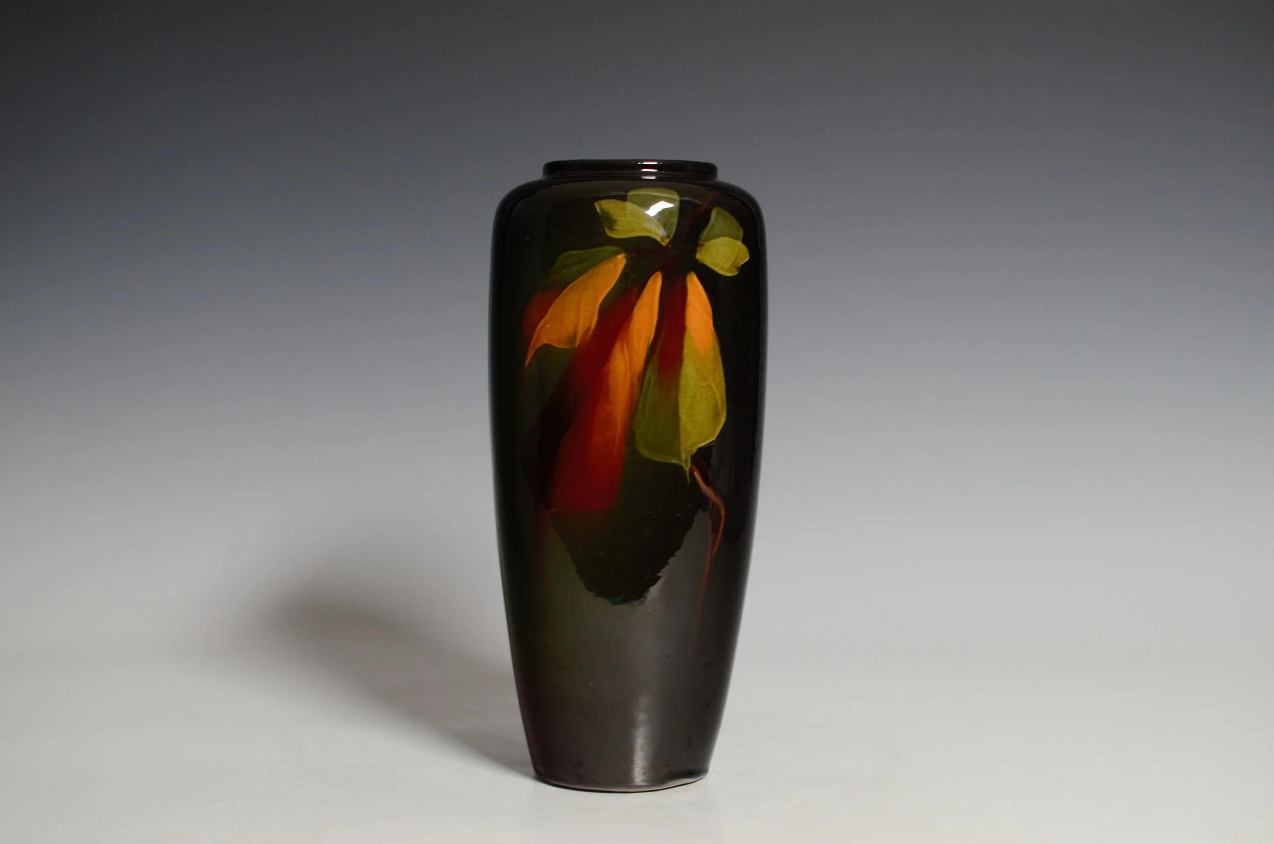 J. B. Owens Pottery Company (1885-1907). Utopian Vase in Black with Orange and Green Leaves