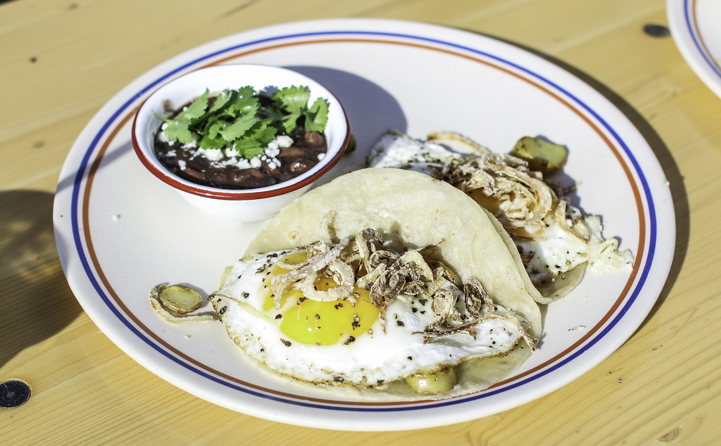  Boardwalk Clasico Tacos: Fried Egg, Fingerling Potatoes, Smashed Avocado, Crispy Shallot served on Housemade Flour Tortillas 