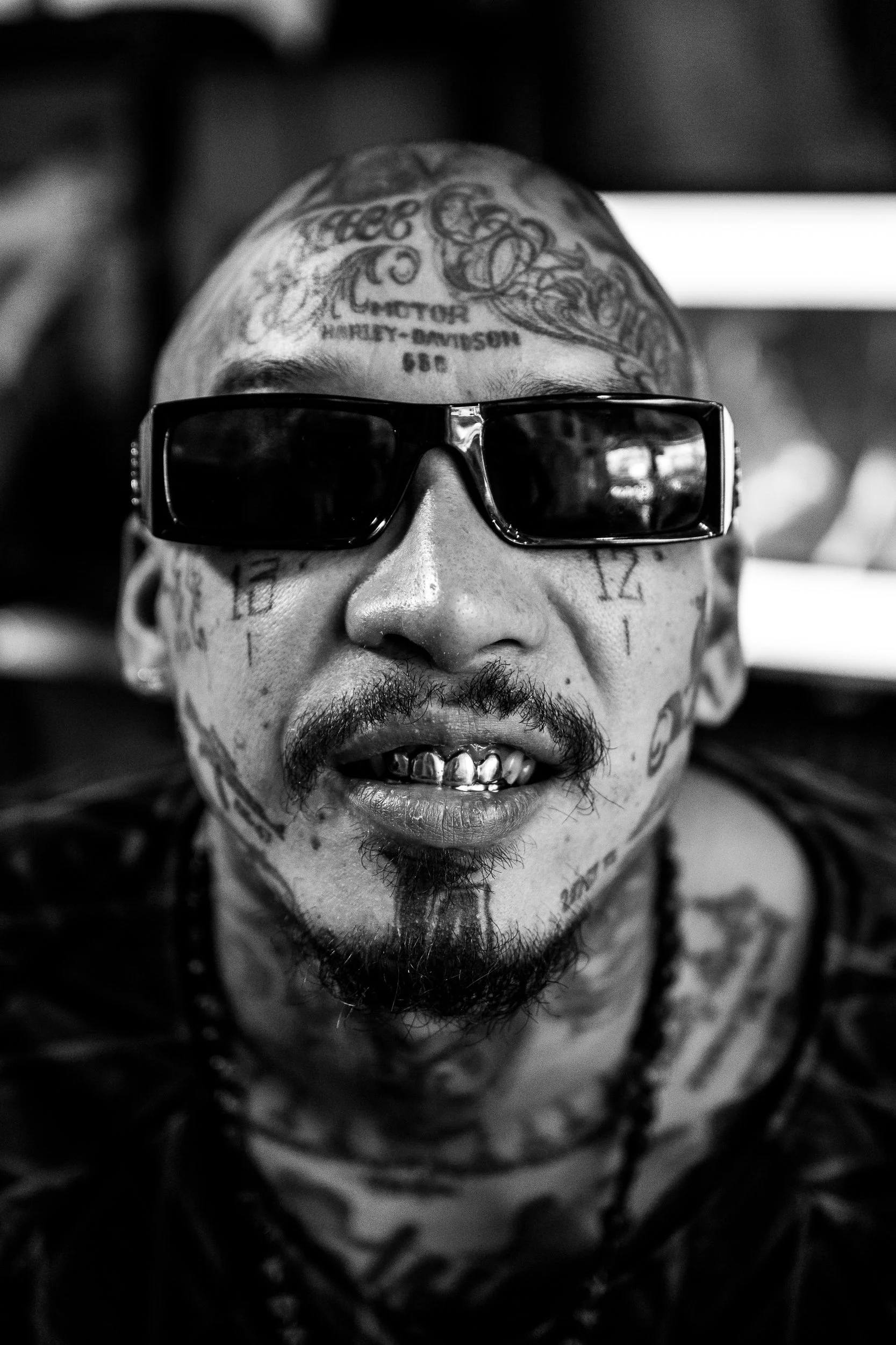 A portrait marked by tattoo, jewelry, and self-presentation.