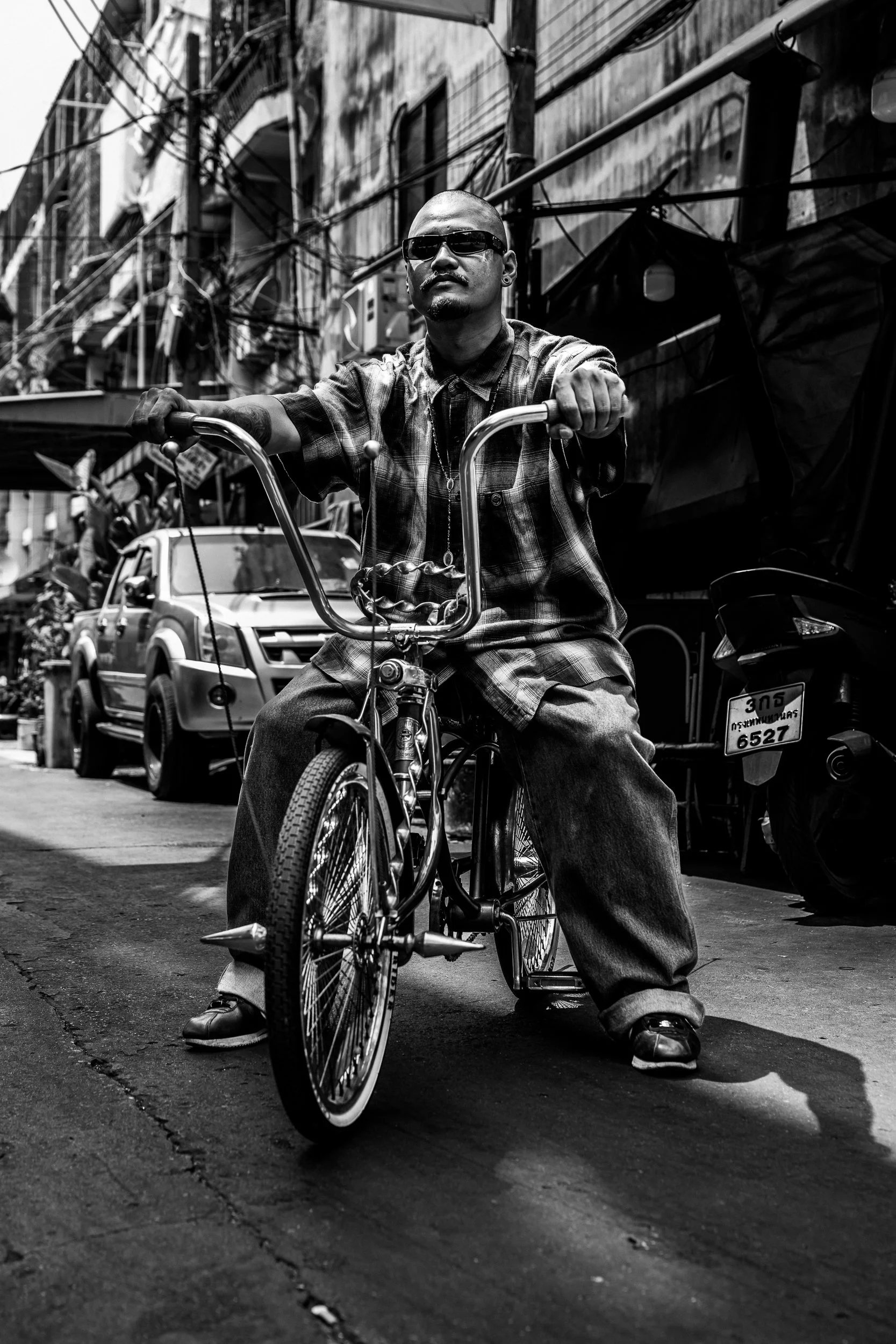 A lowrider bicycle moving through the city streets of Bangkok.