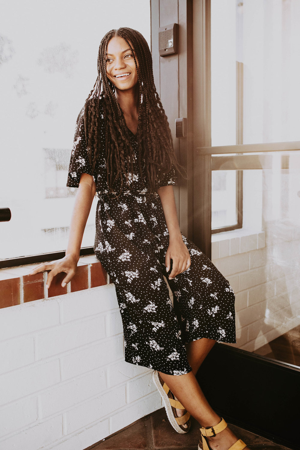 Thrifted black and white floral jumpsuit with modern sandals // A Week Of 1970s-Inspired Outfits With Leah Thomas, The Sustainable Lifestyle Blogger Behind Green Girl Leah on The Good Trade
