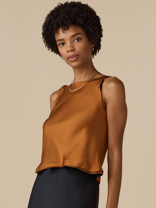 Eco-Friendly Clothing Brands: Model wears Vetta's amber silky crop over a reversible black skirt.