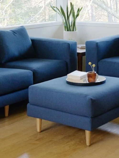 eco-friendly furniture - sabai - blue sofa and ottoman with brown legs in a living room
