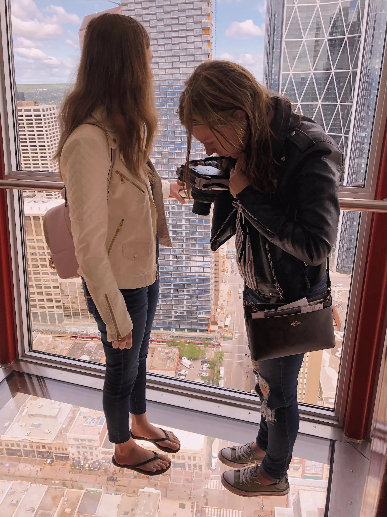 Ashlee and Kirsten taking photos in Calgary Tower.jpg