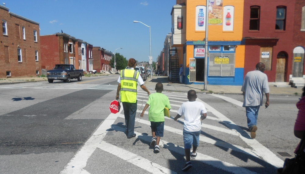 Kids crossing the street after school in East Baltimore. Photo Credit: Tykwan Bernie