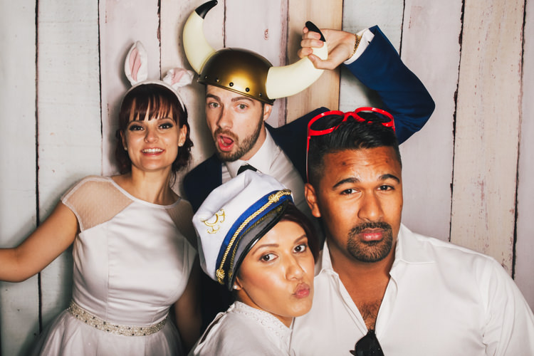 bride-and-groom-brisbane-photo-booth-hire-fun-gone-wild-party-pastel-wood-background-props-reception-wedding.jpg