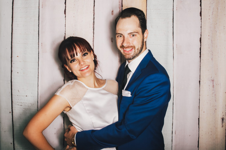 bride-and-groom-brisbane-photo-booth-hire-fun-party-pastel-wood-background-reception-wedding.jpg