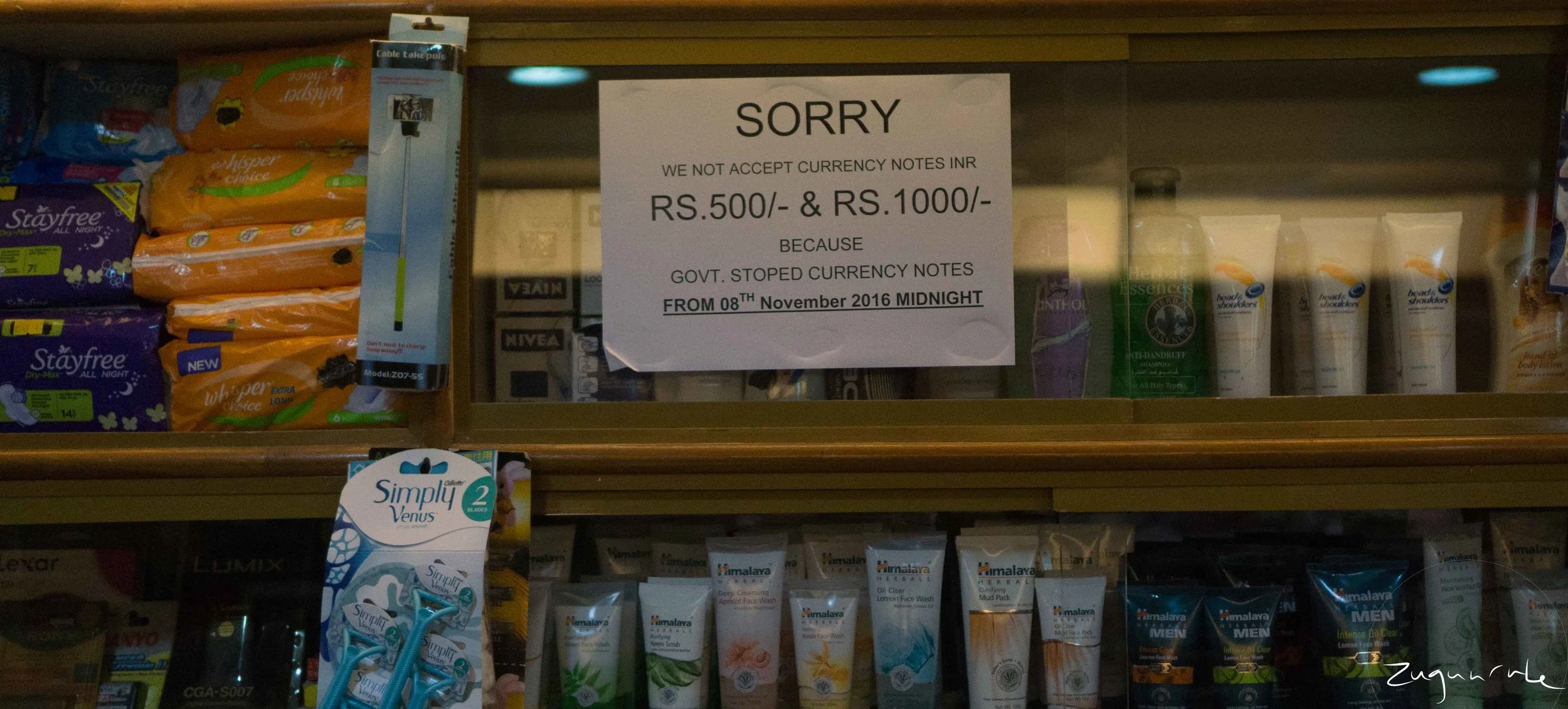 Sign behind the counter of a small convenience store (Udaipur)