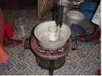 Figure 2: Materials used for the demonstration included cow's milk, a locally purchased glass jar, a locally purchased aluminum pan, and a small charcoal stove that is commonly used for cooking. The temperature probes used in the test are not required in actual practice