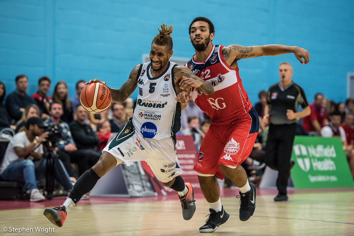 Neil Watson of the Plymouth Raiders fends off Adam Weary of the Bristol Flyers .