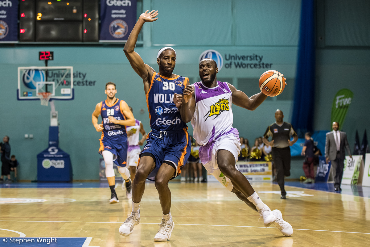 Paul Guede of the London Lions is attempts to get around Jermel Kennedy of the Worcester Wolves .