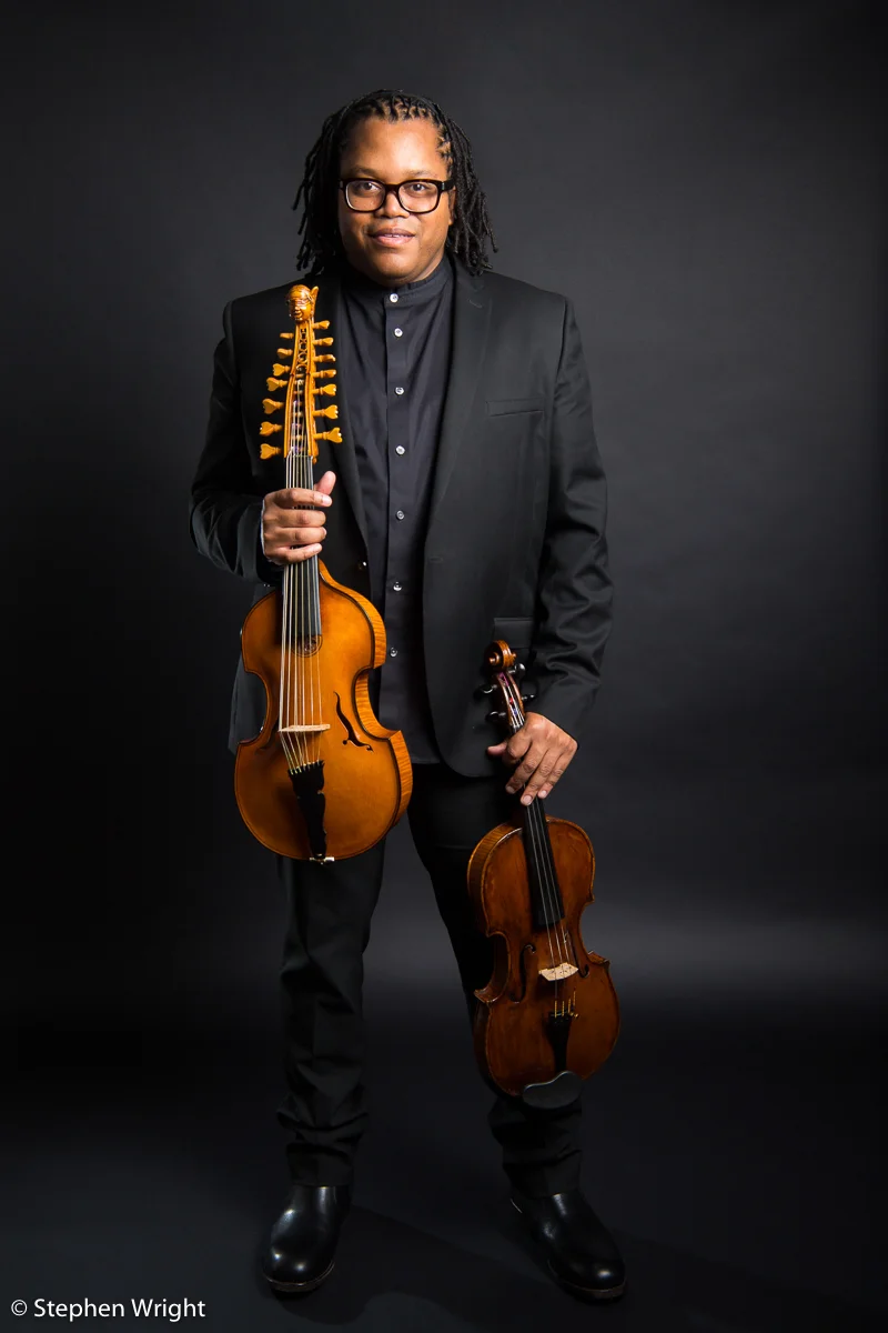 Classical musician, Clifton Harrison on-set with both his Viola and the baroque Viola d'Amore.