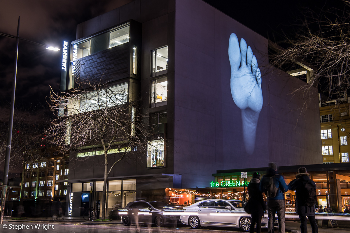 The Rambert building as part of the Lumiere London festival. Images of the dancer's feet by artist David Ward .