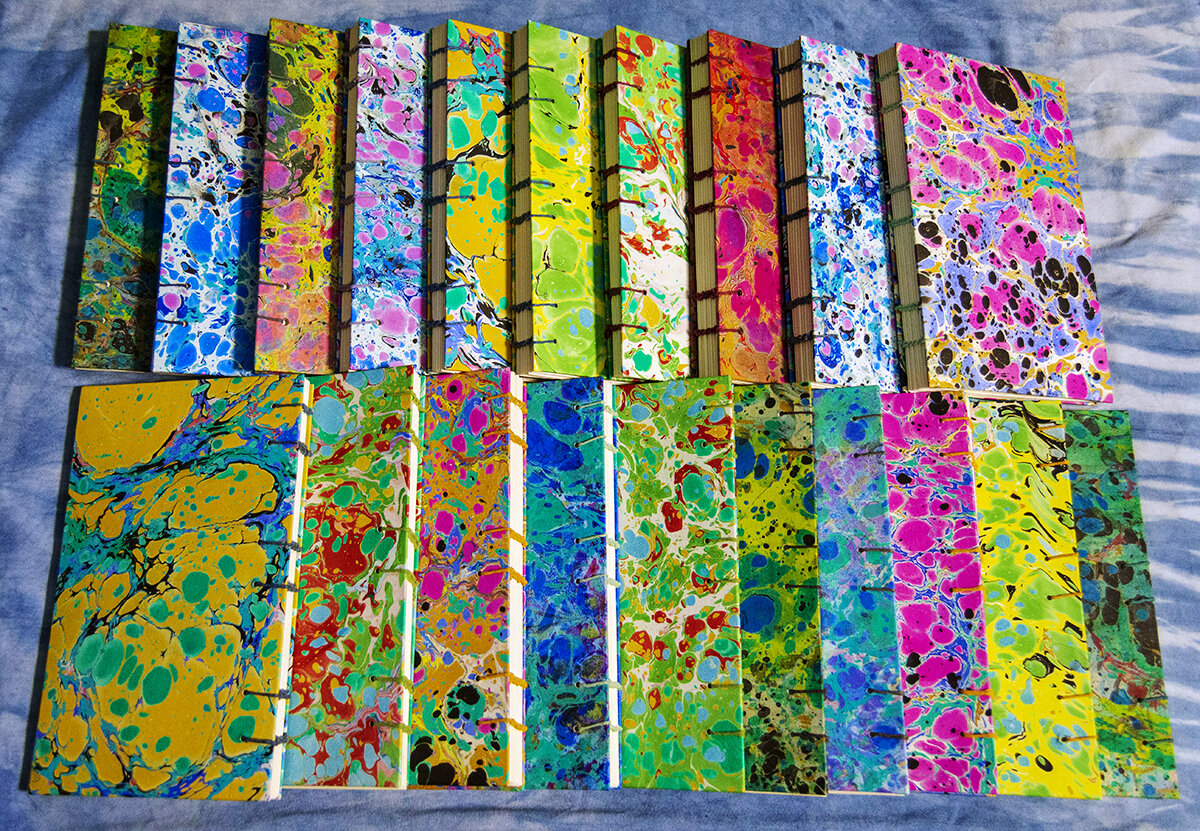  Twenty new hand marbled coptic bound blank journals. 