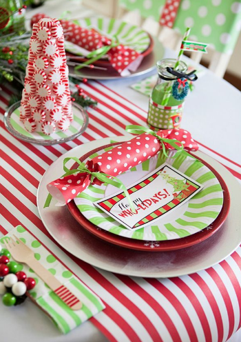 Your guests will love the extra time and attention you put into a beautiful table setting for your dinner party. We love the layered green and red details of this table. Consider using bold patterns and festive candy details to complete a beautiful table. 