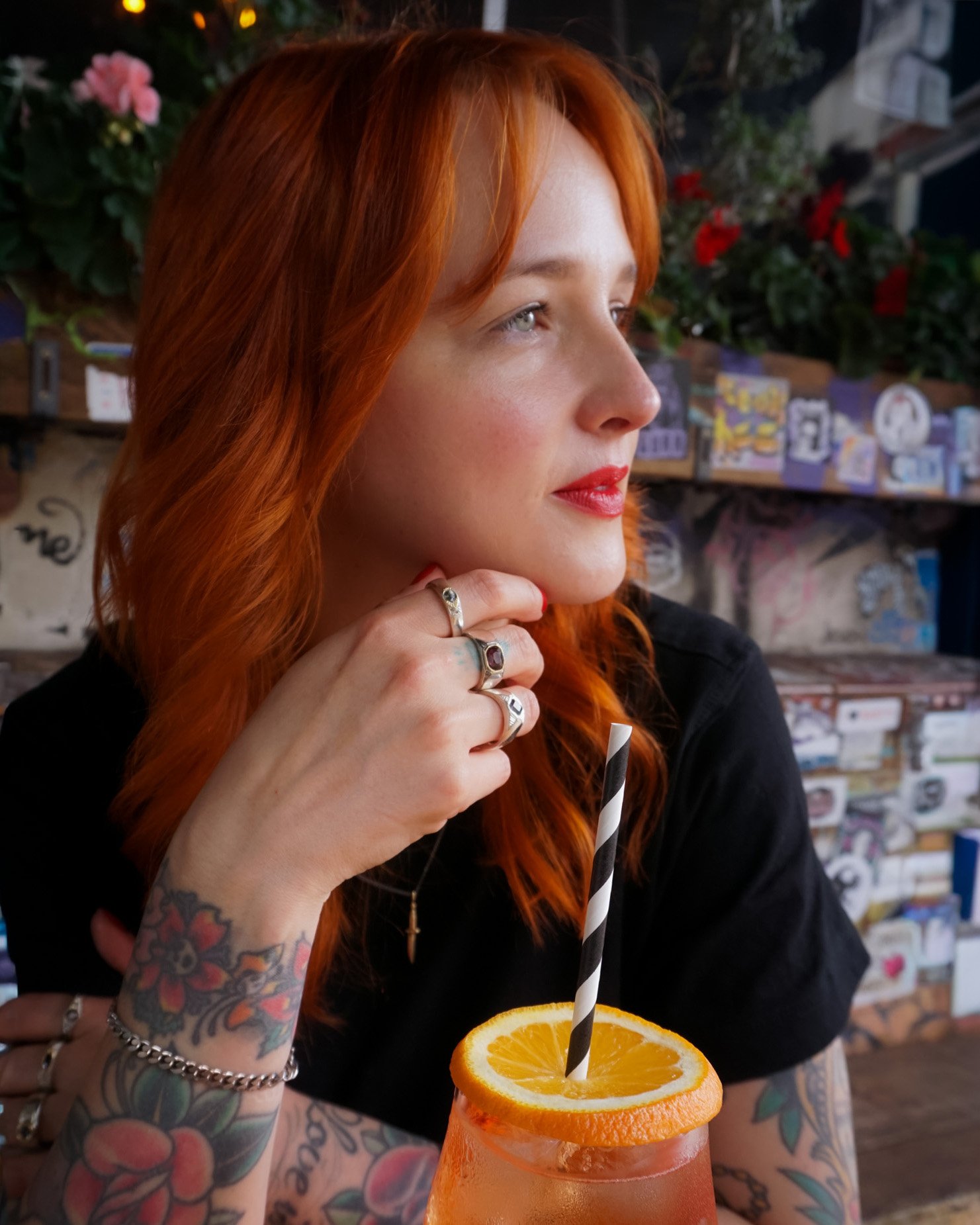 A woman wears hand engraved statement rings outside a Kreuzberg bar