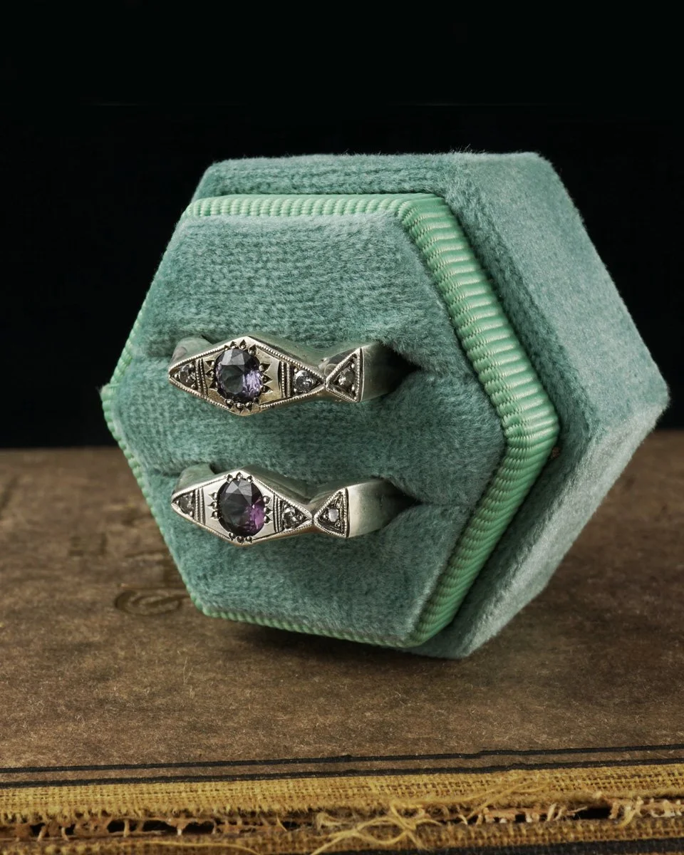 This image features two Queen of Scots Rings, each sterling silver with a purple spinel center stones and salt and pepper diamond accents with hand engraved details