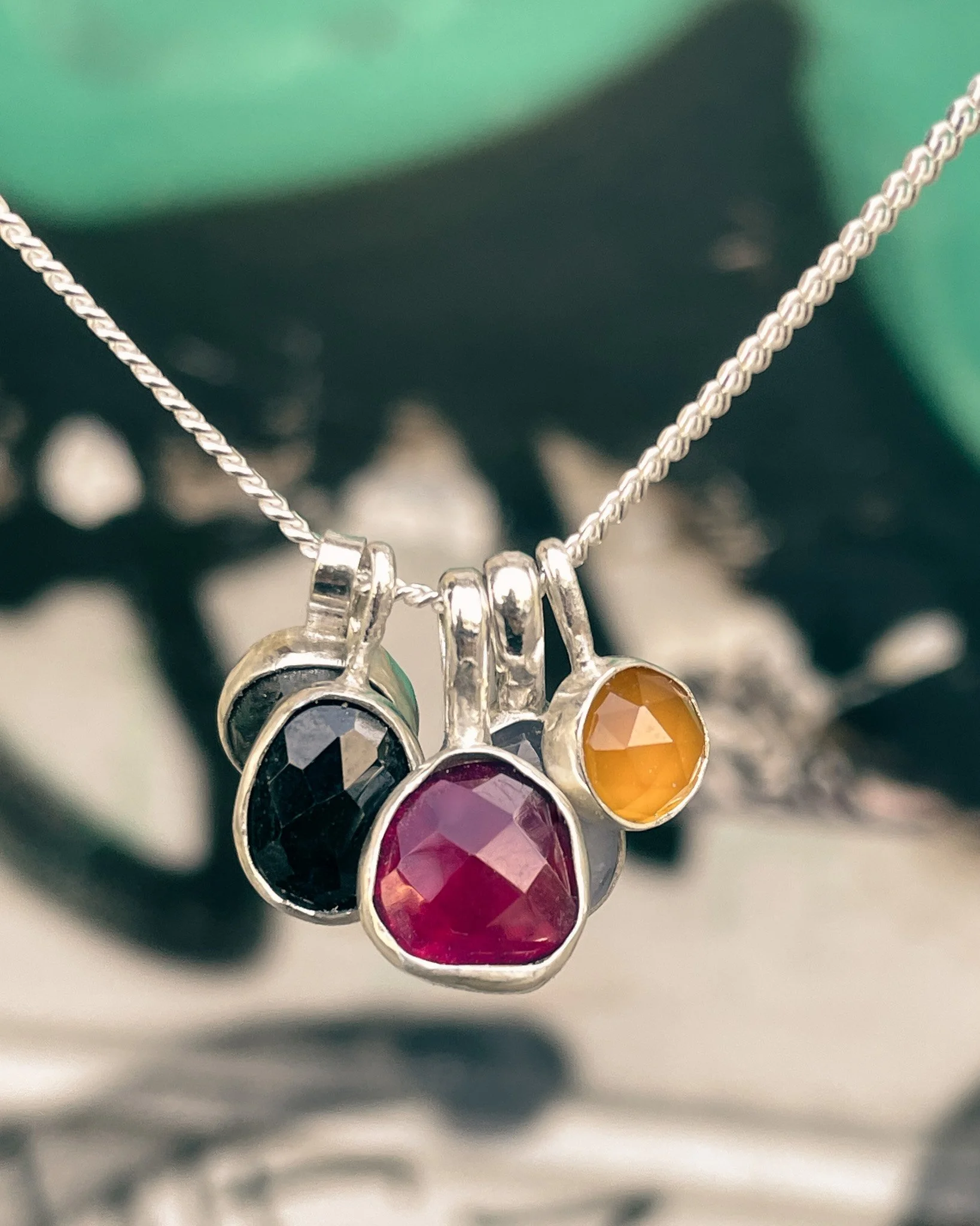 This image features colourful gemstone pendants on a chain, made in a fun jewelry class in Kreuzberg, Berlin