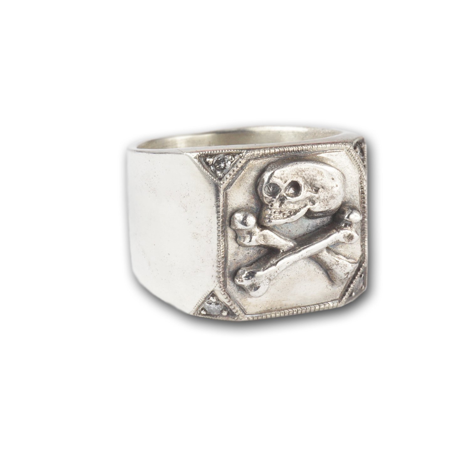 This image is a silver skull ring with salt and pepper diamond accents