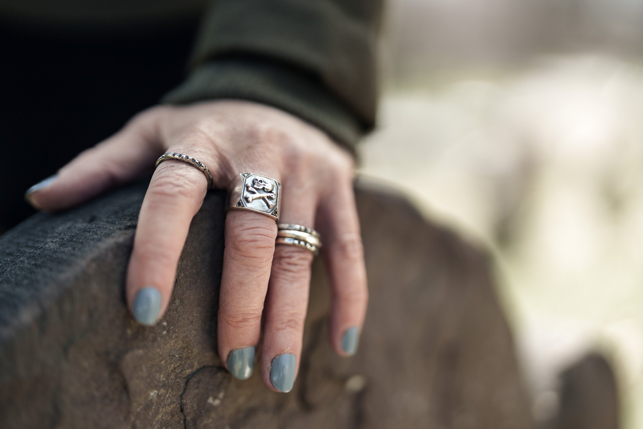 Silver memento mori skull ring and pyramid stud stackers worn by DJ Sindi Halfrats