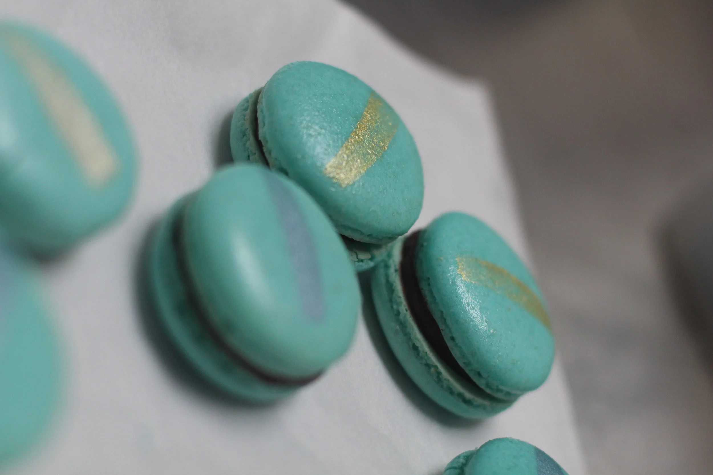 Our first batch of single-origin chocolate macarons, color coded with luster dust to match the Washi tape found on our bar packaging. At our commercial kitchen, Omfk. May 7, 2018. Photo Credit: Will Dixon. 