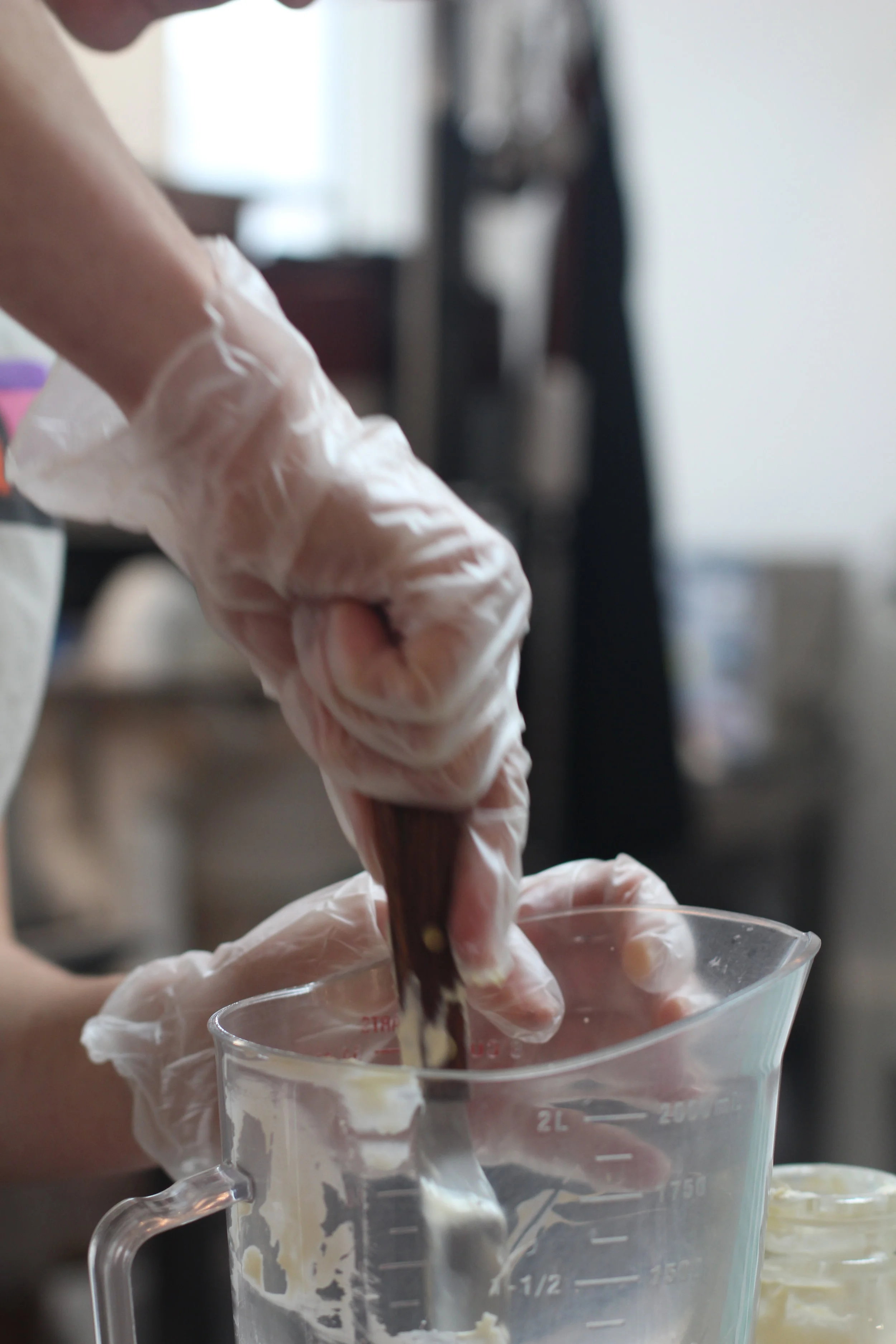 Cornelia, prepping the ganache. She needed vodka for the luster dust. At our commercial kitchen, Omfk. May 7, 2018. Photo Credit: Callie Neylan.
